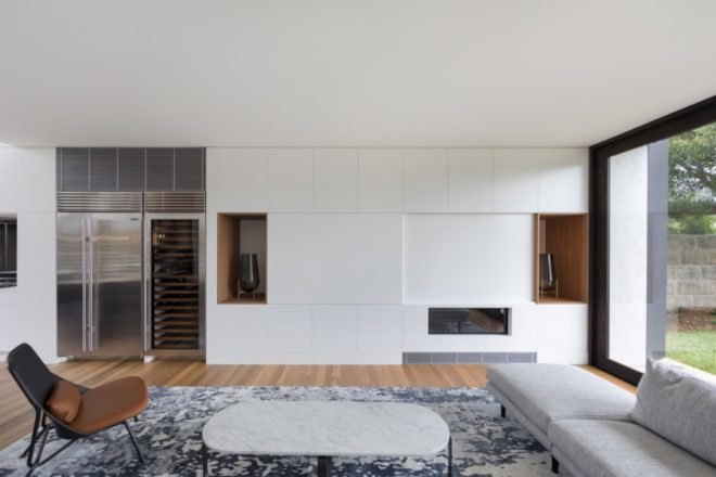 living area with gray rug, hardwood floors and white walls