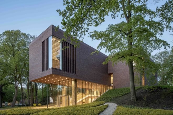 side view of brick and glass museum at dusk