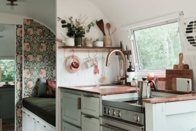 small kitchen with brass and green accents