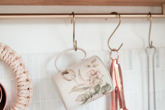 flowered coffee mug hanging in kitchen