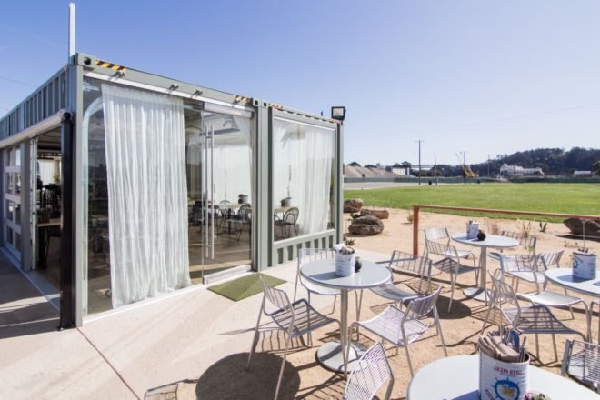 outdoor dining area in front of two shipping containers