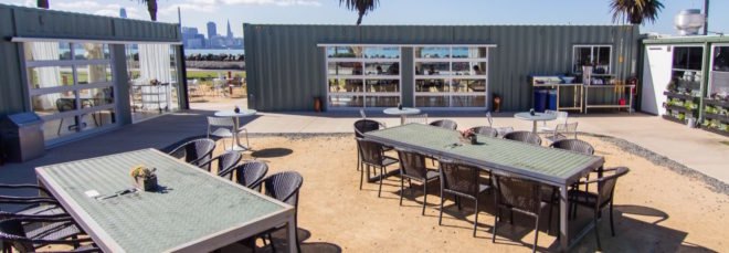 outdoor dining area surrounded by shipping containers