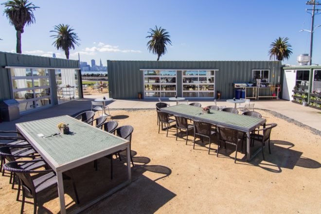 outdoor dining area surrounded by shipping containers