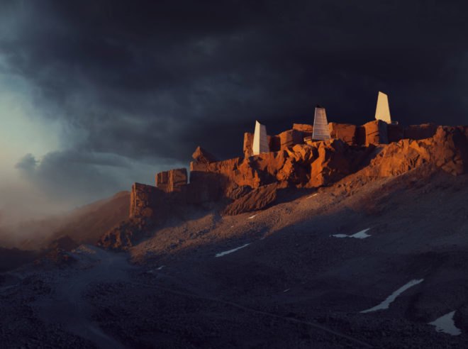 a series of fabric-covered structures on rugged landscape at night