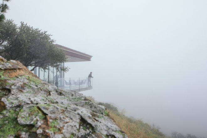 home overlooking hill in the mist