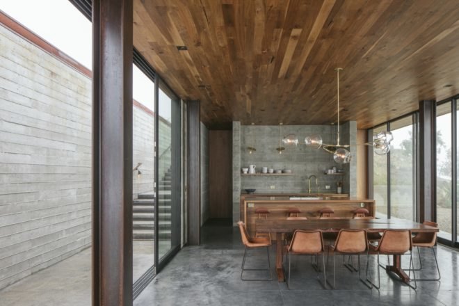 open plan living area with timber ceiling and glass walls