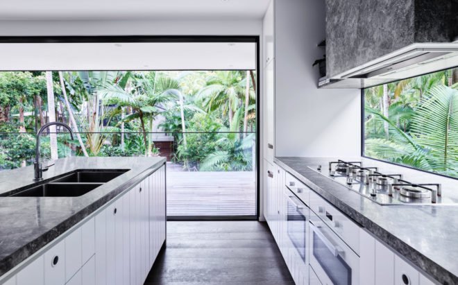 Bright kitchen with large island and glass walls