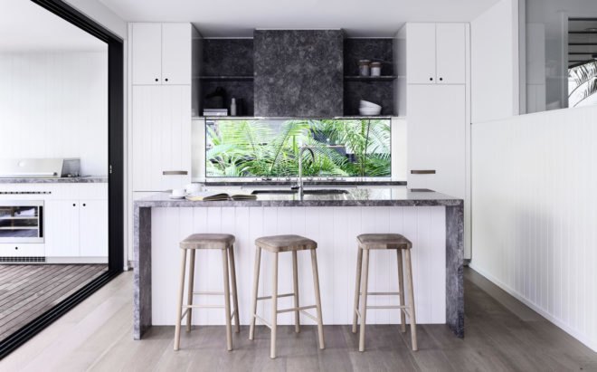 Kitchen with large island and glass wall serving as backsplash