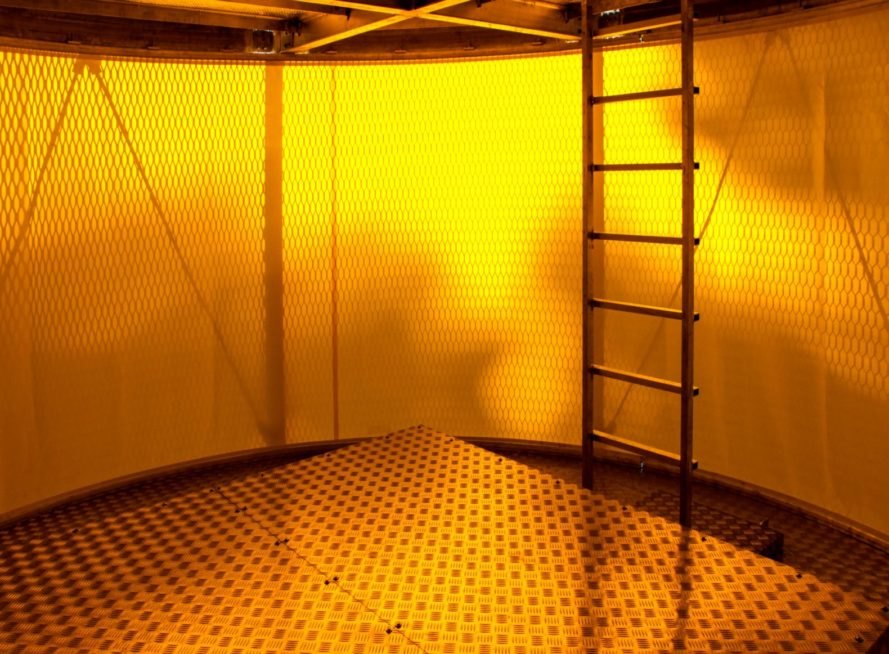 yellow-hued round interior with ladder