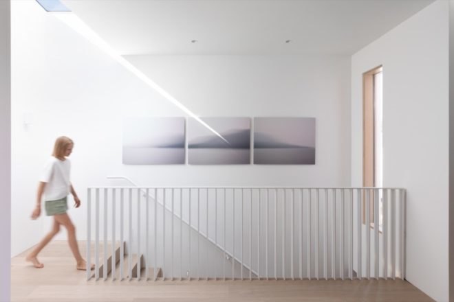 child walking down light timber stairs
