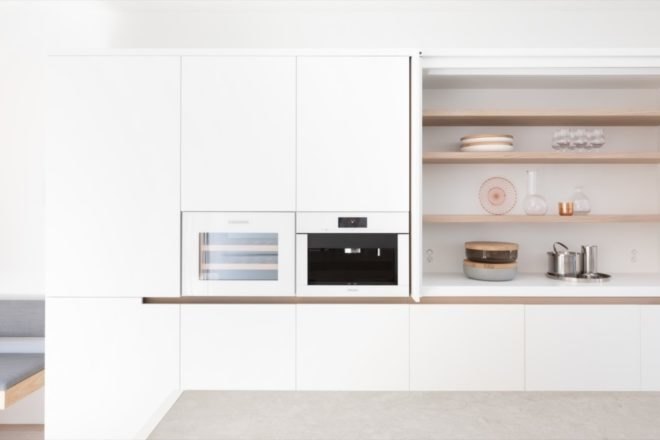 kitchen with white cabinetry and light timber open shelves