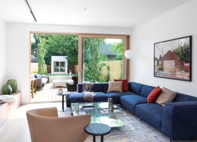 living room with blue sectional sofa and large sliding glass door to outside patio
