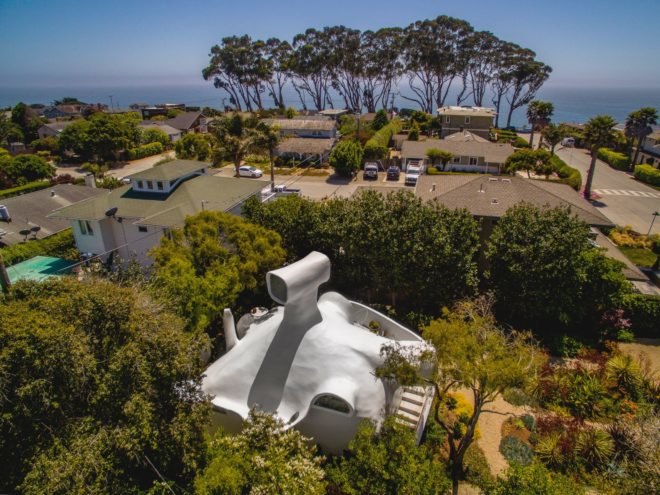 an all-white structure with a periscope-like lookout on the roof