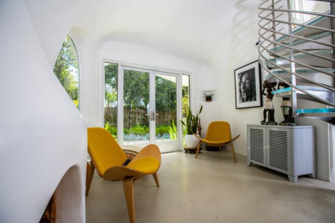 an interior room with chairs and a large glass doorway