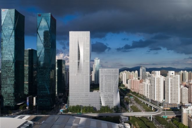 light gray skyscraper with concave facade