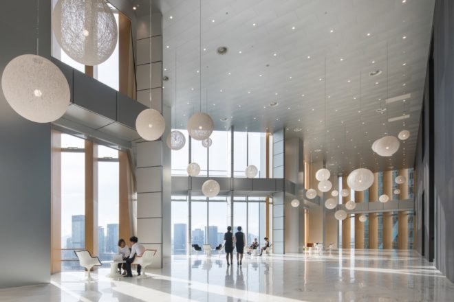 interior view with full height glazing and rounded pendant lamps
