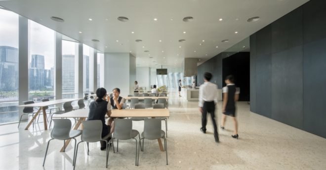 interior of dining space with wood desks and light gray chairs