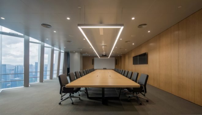 meeting and conference room with large wood table and several chairs