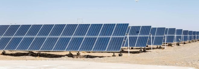 solar panels in a desert under a blue sky