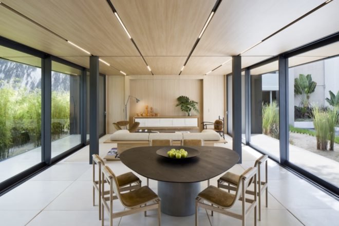 living area and dining table divided by pillars