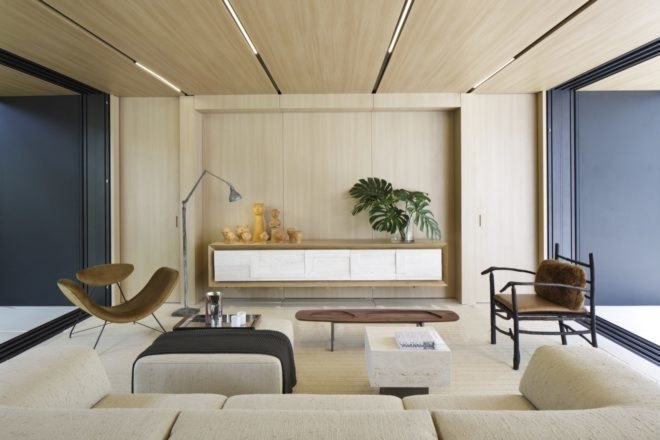 wood paneled living space with couch, two chairs and an ottoman