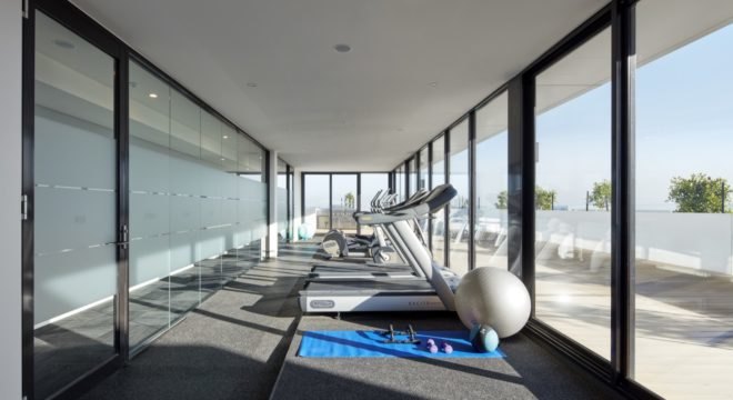 fitness center with wall windows