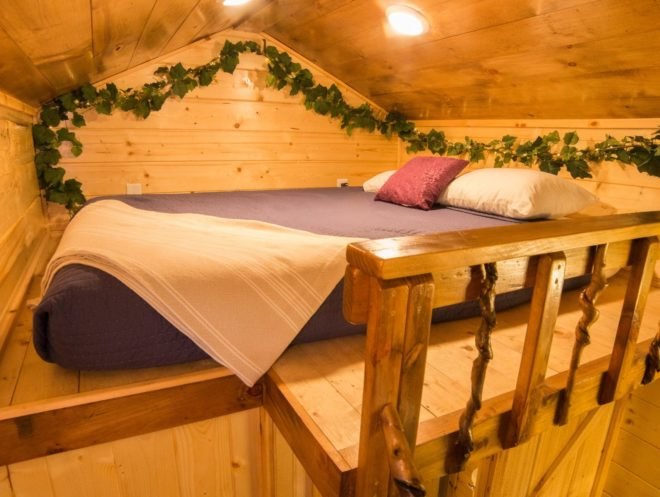 a sleeping loft with queen sized bed