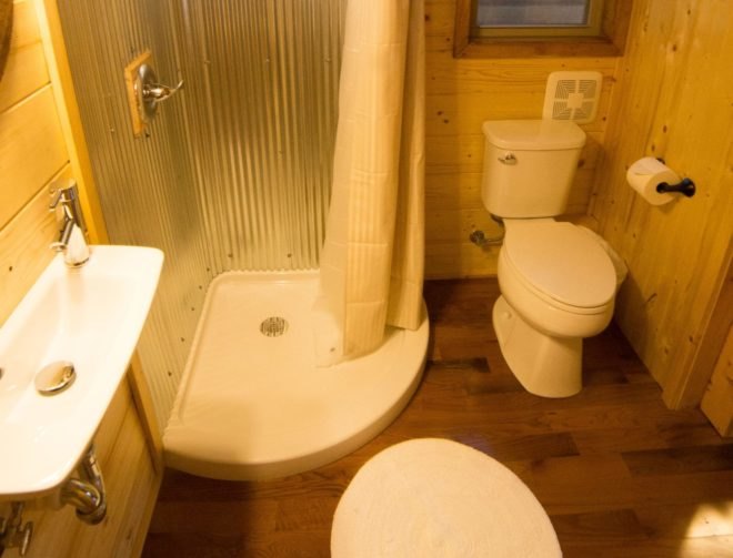 a bathroom with shower, toilet and sink