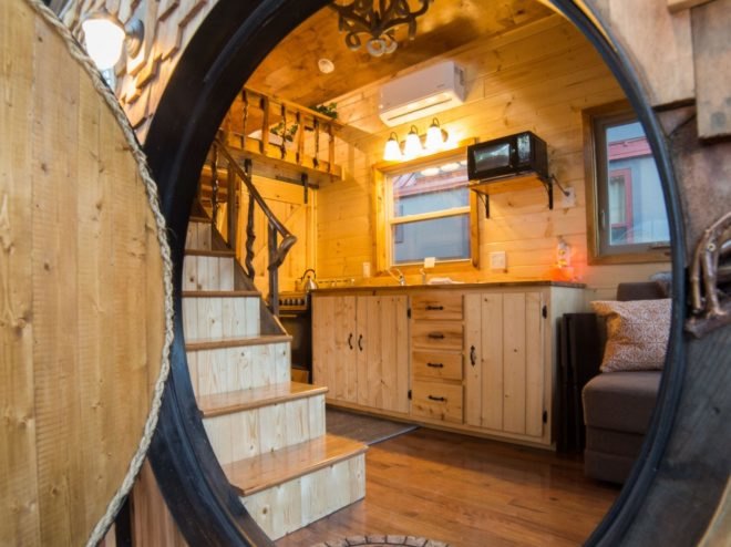view of kitchen and living area through the circular door