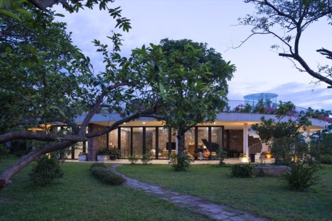 house at dusk with tree in front