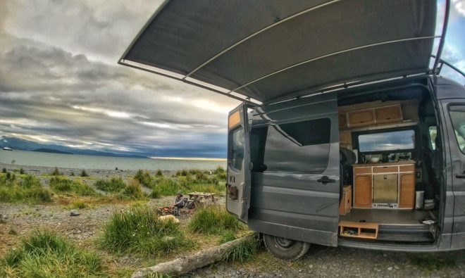 black van with open side door revealing bamboo cabinetry inside