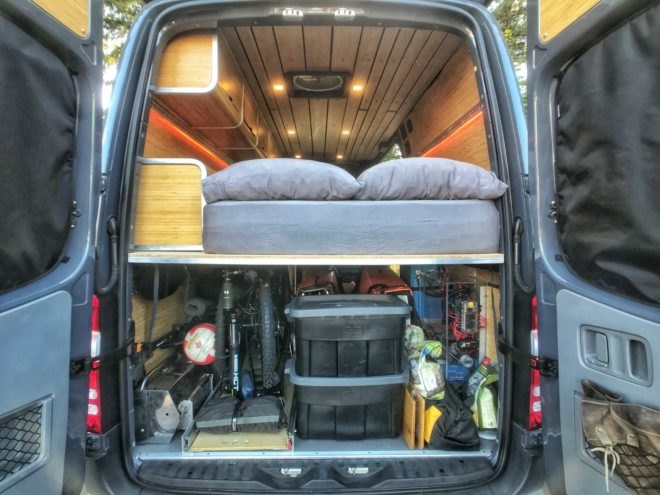 back of converted van with sleeping platform
