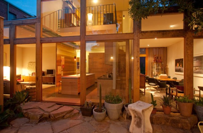 interior living quarters with glazed wall lit up at night