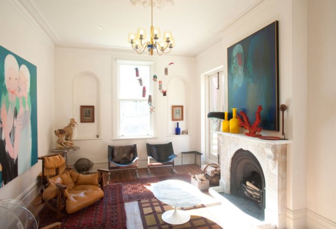 brightly lit living room with fireplace and chandelier