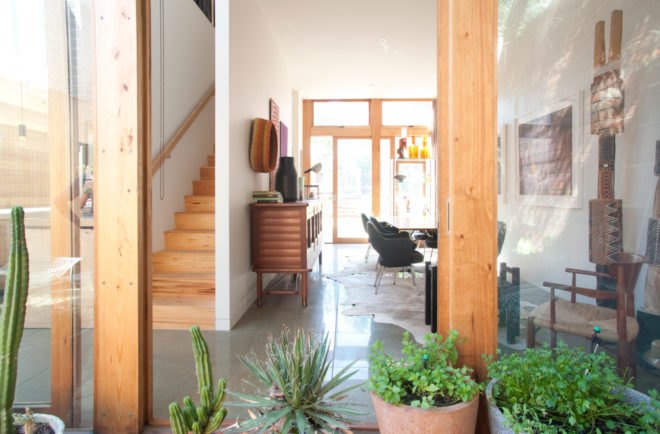 open living space with wooden staircase and wooden column