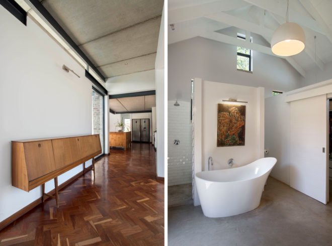 On the left, herringbone patterned wood floors and white walls. On the right, modern curved freestanding tub in all-white bathroom with high ceilings.