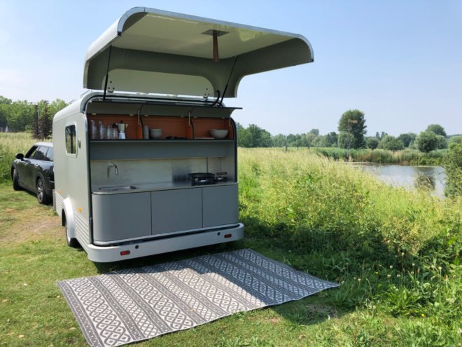 back of trailer opened up to reveal small outdoor kitchen space