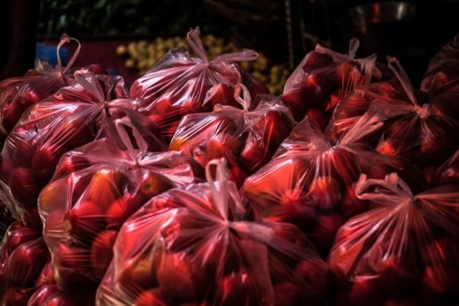 red plastic bags filled with fruit
