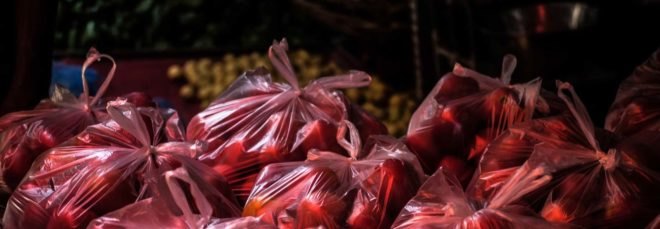 red plastic bags filled with fruit