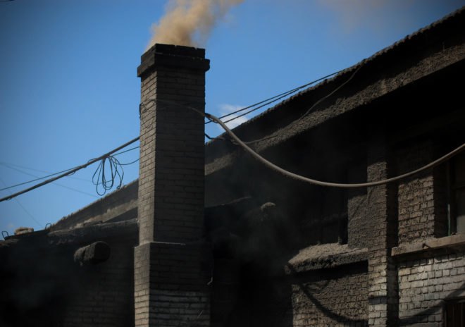 Brick building coated in dark coal dust