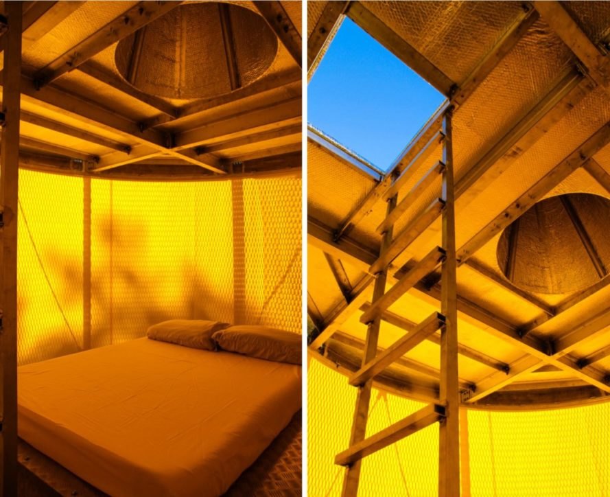 yellow-hued interior with ladder leading out to a rooftop deck