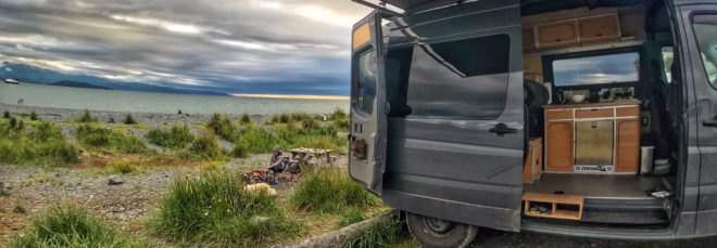 black van with open side door revealing bamboo cabinetry inside