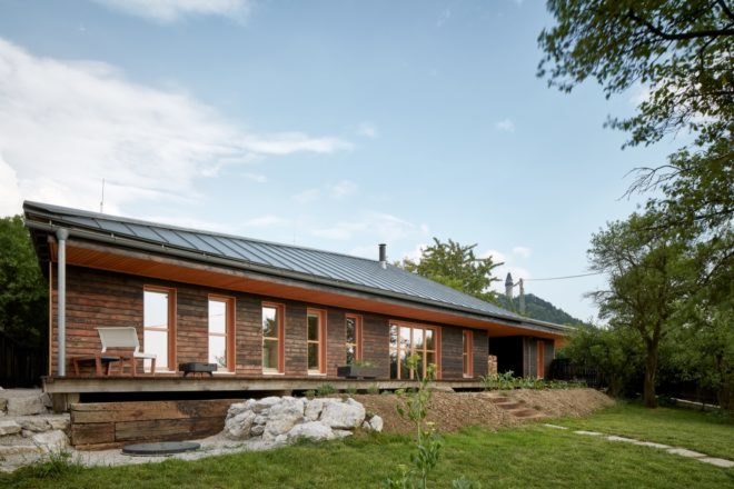 angled view of dark timber home with sloped roof