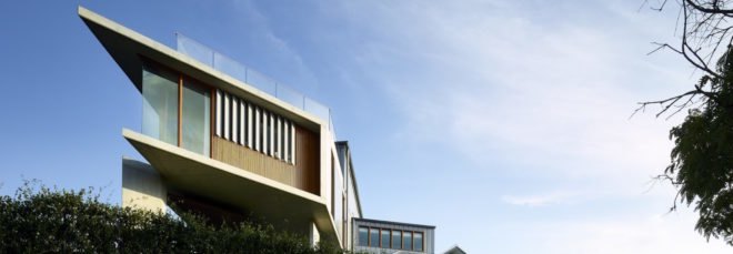 cropped close-up of concrete and timber home on a cliff