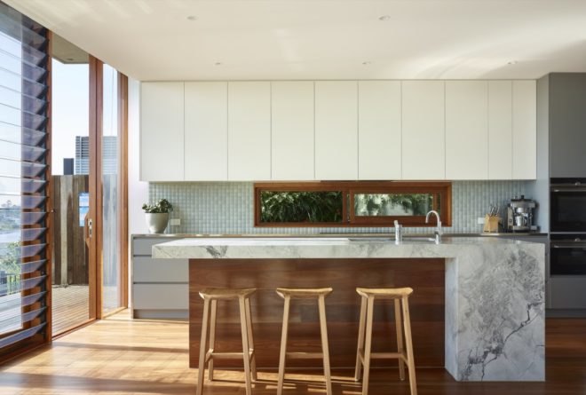 marble and wood kitchen island with wood bar stools