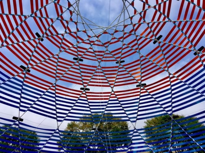 dome made with red and blue seatbelts and rearview mirrors