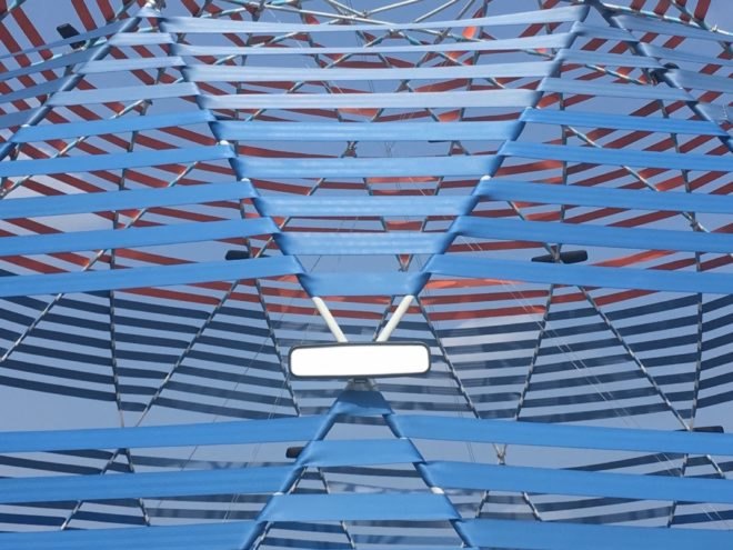 blue seat belts and a rearview mirror on a dome