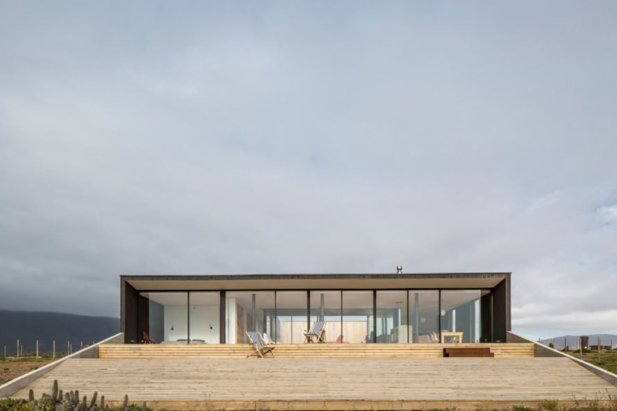 a home with a glazed facade leading to a patio