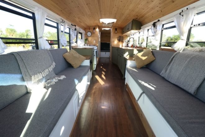 two long gray couches inside a bus