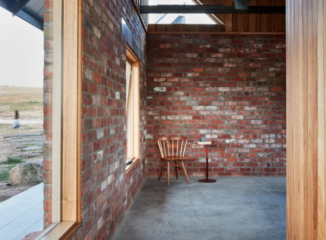 small wood chair and table next to large window